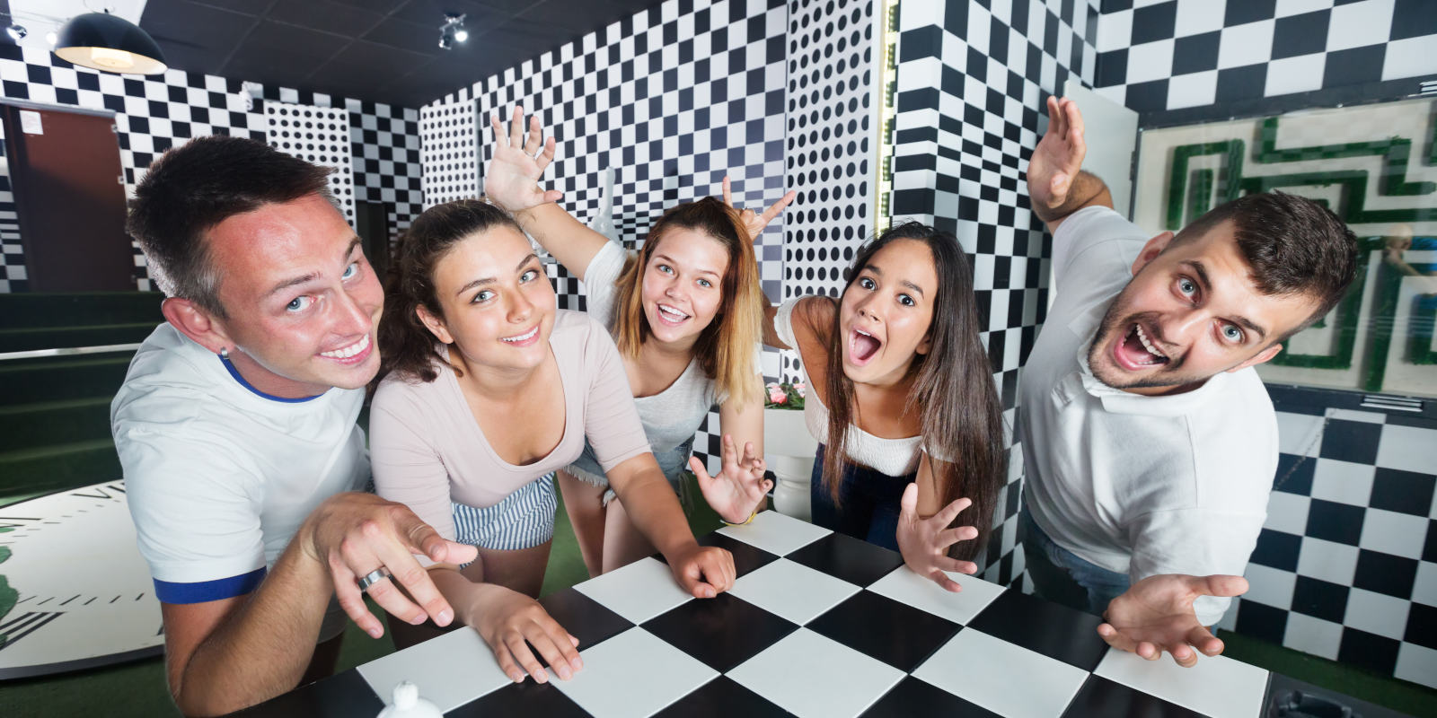 a group of work colleagues in an escape room participating in a corporate event